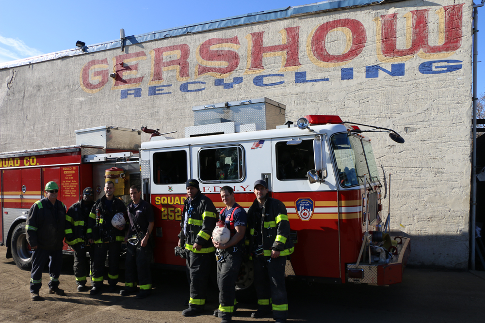 Eric Kugler (left), Manager, Gershow Recycling, presented turkeys to members of Fire Department of New York Rescue Squad 252.