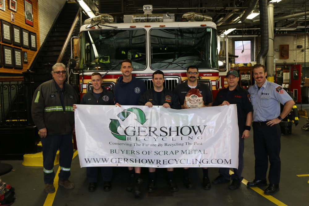 Eric Kugler (left), Manager, Gershow Recycling, presented turkeys to members of FDNY Engine 231/Ladder 120 at Watkins Avenue.