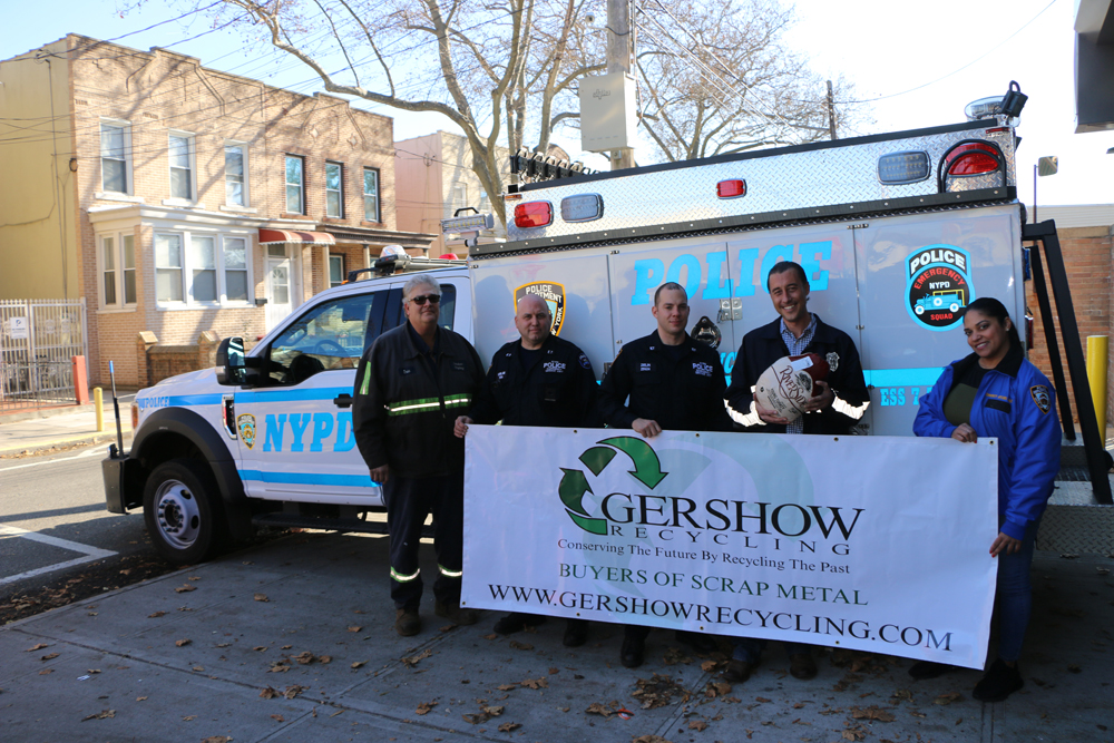 Eric Kugler (left), Manager, Gershow Recycling, poses with members of New York Police Department’s Emergency Services Unit Truck #7 and the 75th Precinct and one of the turkeys donated by Gershow.