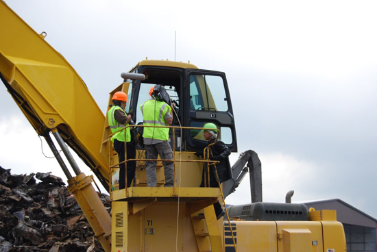 Cameras roll as "Sci-Fi Science: Physics of the Impossible" host Dr. Michio Kaku prepares to get into a crane at Gershow Recycling's Medford facility to operate one of the super magnets.