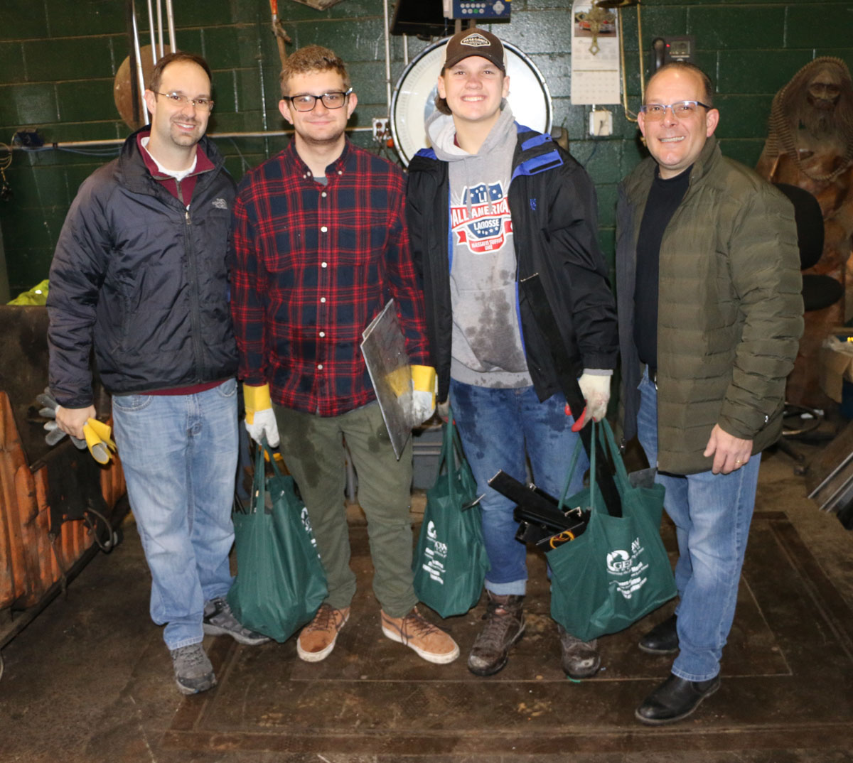 North Shore High School Robotics Team Coach Steve Peroni, Team Members Louis Lavenda and Gavin Mason and Gershow Manager Jonathan Abrams.