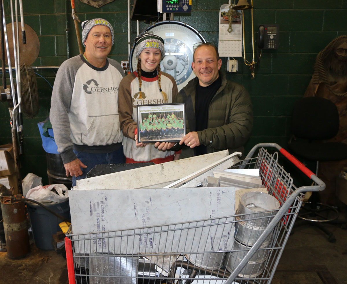 Westhampton Beach High School Robotics Team Coach Tony Kryl, his daughter Michelle Kryl and Gershow Manager Jonathan Abrams.