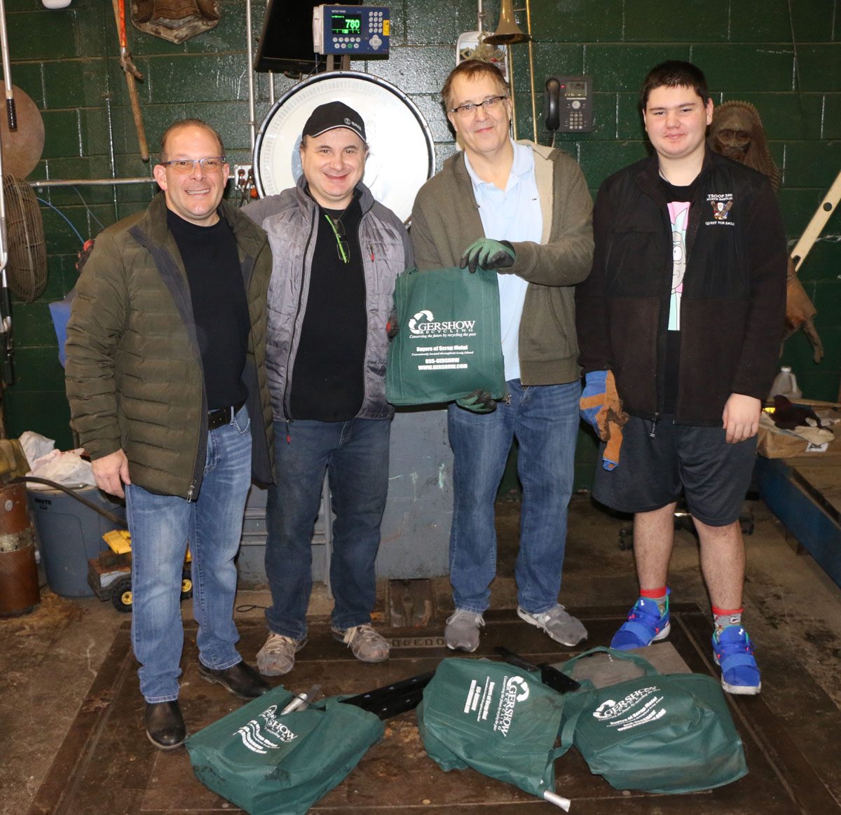 Gershow Manager Jonathan Abrams, Half Hollow Hills High School Robotics Team Coaches Yury Wolf-Sonkin and Michael Patrick and Team Member Dalton Asch.