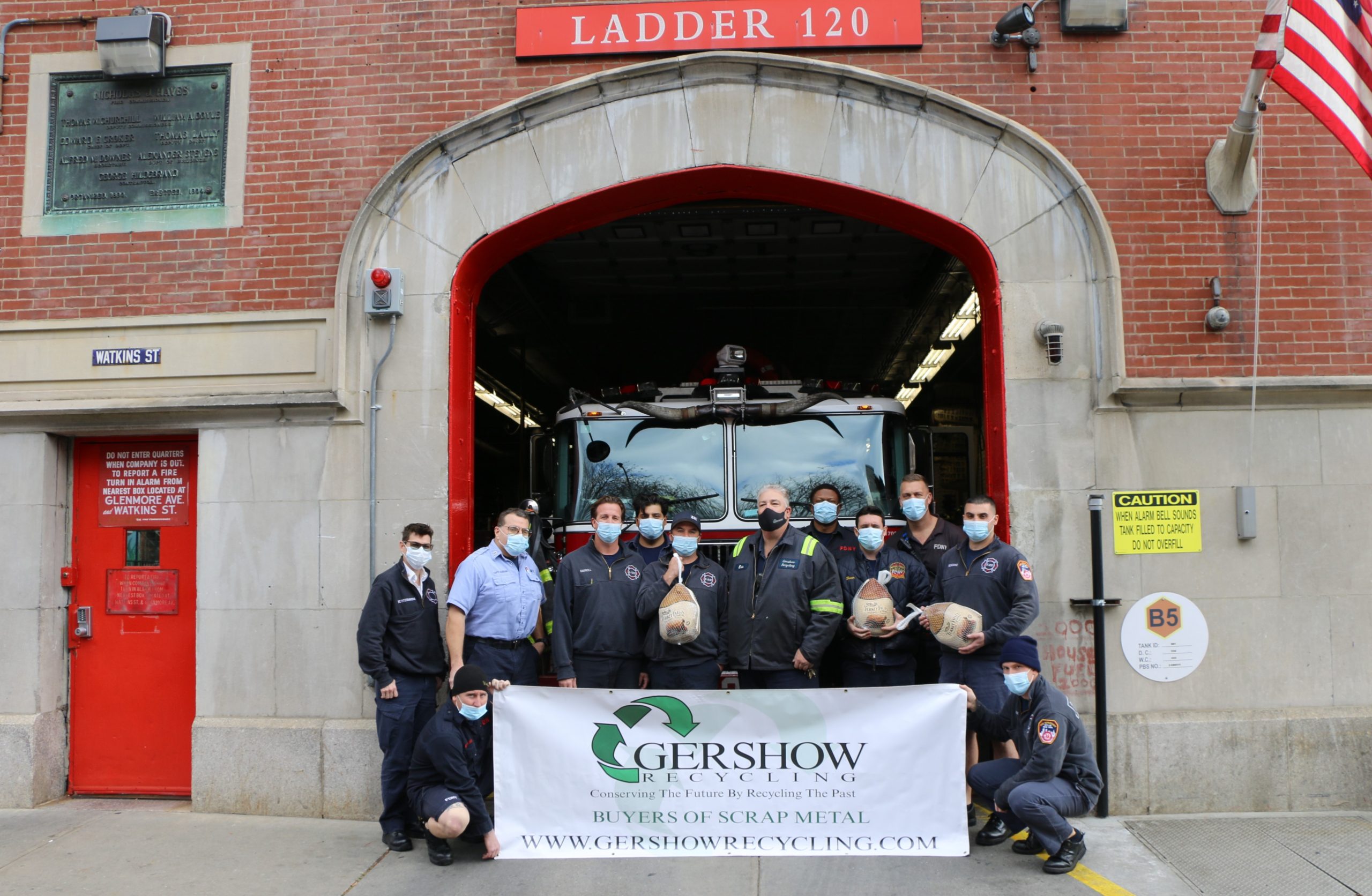 Eric Kugler (standing, fifth from right), Manager, Gershow Recycling, presented turkeys to members of FDNY’s Engine 231/Ladder 120 at Watkins Street.